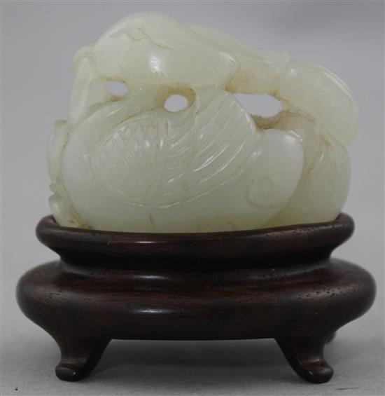 A Chinese white jade carving of two mandarin ducks, 18th / 19th century, 4.8cm., wood stand